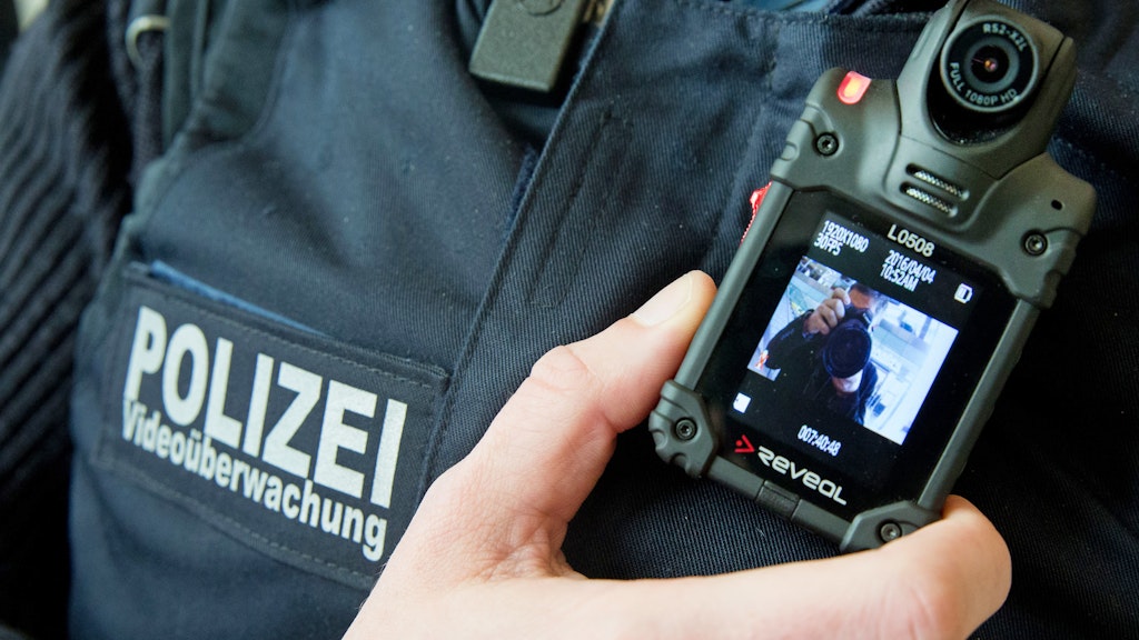 Ein Beamter der Bundespolizei zeigt im Ostbahnhof in Berlin eine Bodycam zur Videoüberwachung.