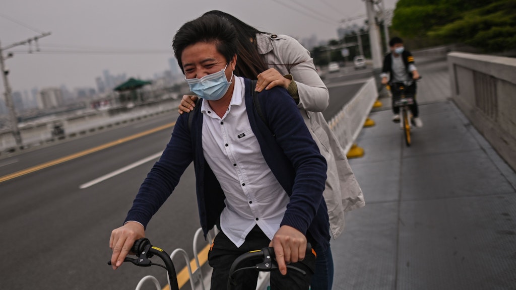 Ein Paar ist in Wuhan gemeinsam mit dem Fahrrad unterwegs.