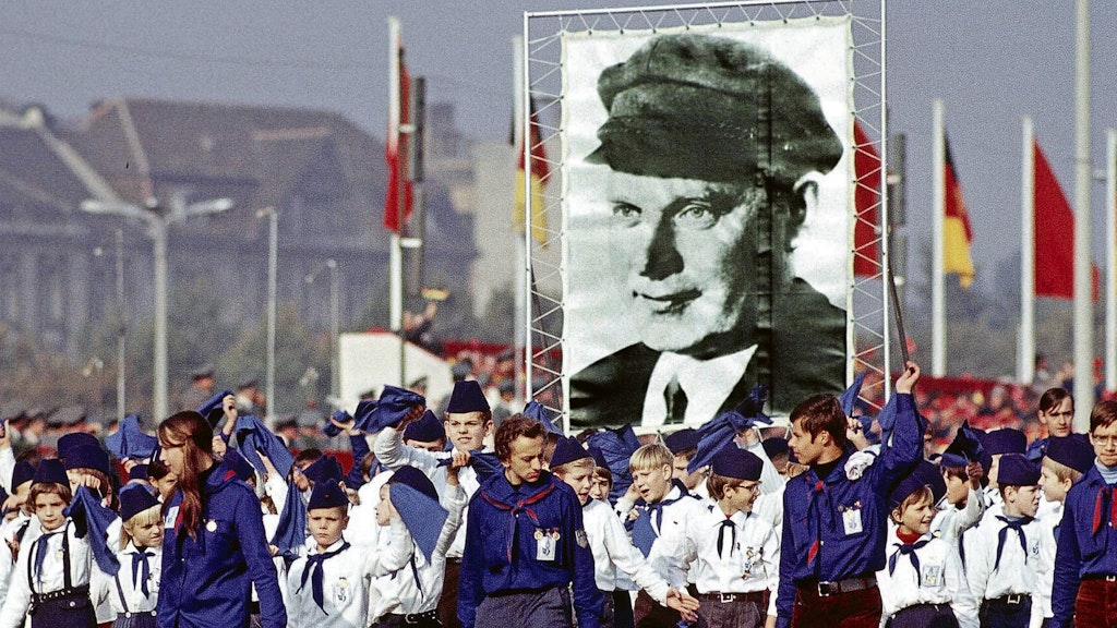  <br><br>Pionierumzug im Jahr 1969 zum Jahrestag der Deutschen Demokratischen Republik, begleitet von FDJlern im Blauhemd.