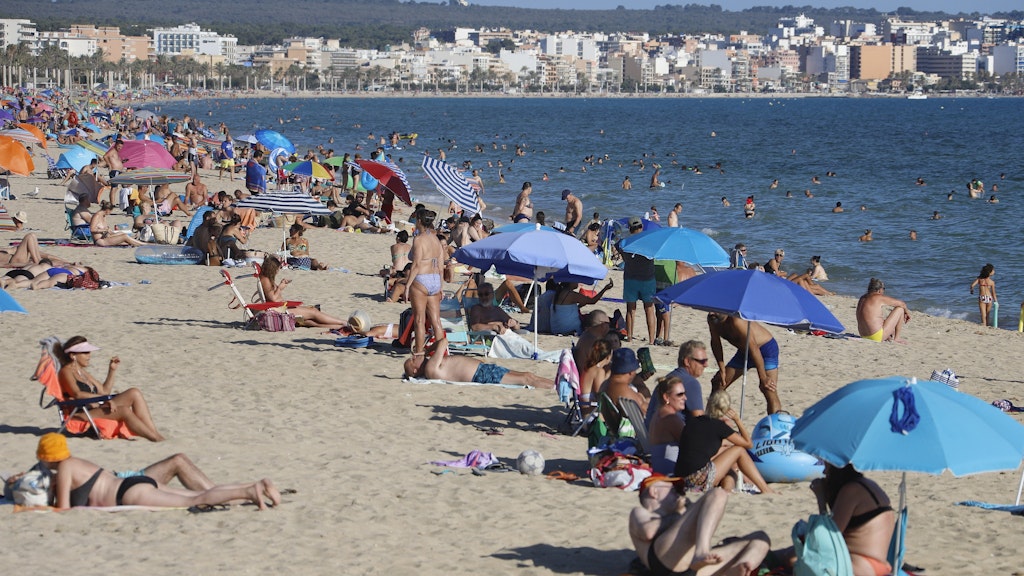 Menschen genießen die Sonne am Strand von El Arenal. 