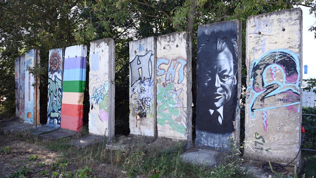 Bemalte oder mit Farbe besprühte Teile der Berliner Mauer stehen auf einem Industriegelände nahe dem Hafenbecken am Teltowkanal.