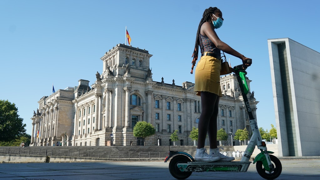 Reichstag. Weird modernist building. E-scooter. Berlin.