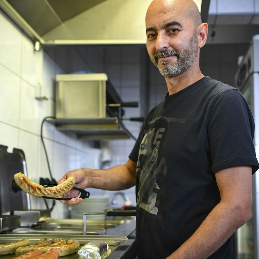 Gökhan Dogan at the grill in Curry 32 - where the house specialities are Currywurst and Schnitzel. 