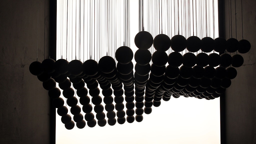 Like an underwater creature. Inverse combines 169 moving spheres with motors and winches