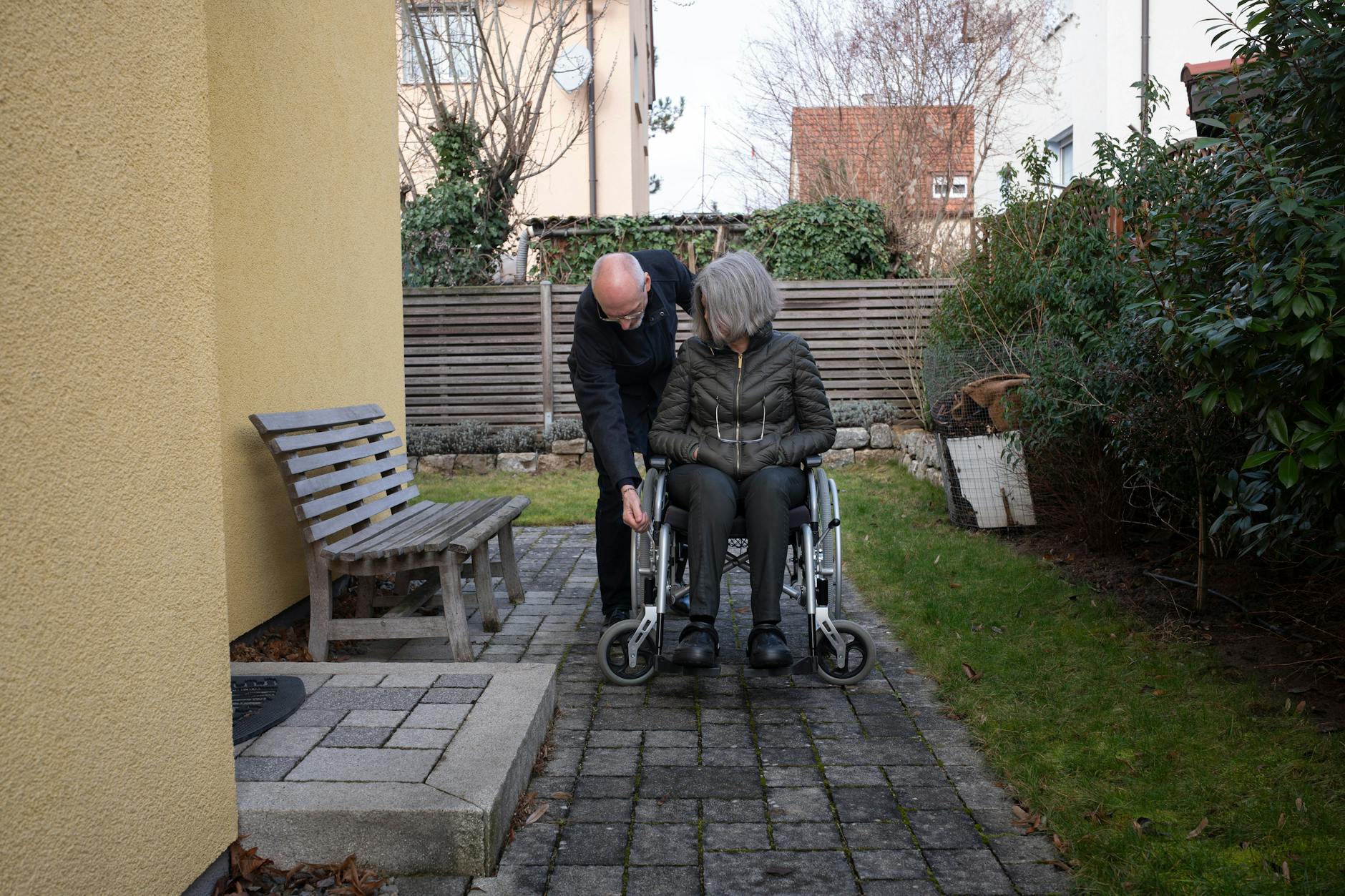 February 11, 2024, Stuttgart, The case of Erika Seebacher: After receiving the AstraZeneca COVID-19 vaccine, Mrs. Seebacher became seriously ill. She is not anti-vaccination, but wants to understand for herself and others what is happening to her body. Mrs. Seebacher relies on her husband's help for everything; she doesn't have enough strength to release the wheelchair brake.